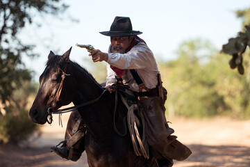 A cowboy on a rearing horse holding a revolver, capturing a classic and dramatic