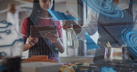Daughter tapping tablet and mother pouring oil in kitchen, blue AR charts guiding food tech process - Powered by Adobe