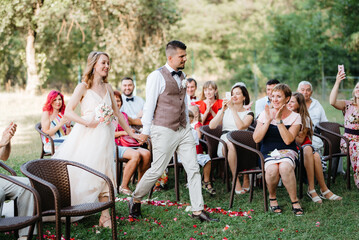 wedding ceremony of a young couple in love on a green meadow © omelnickiy