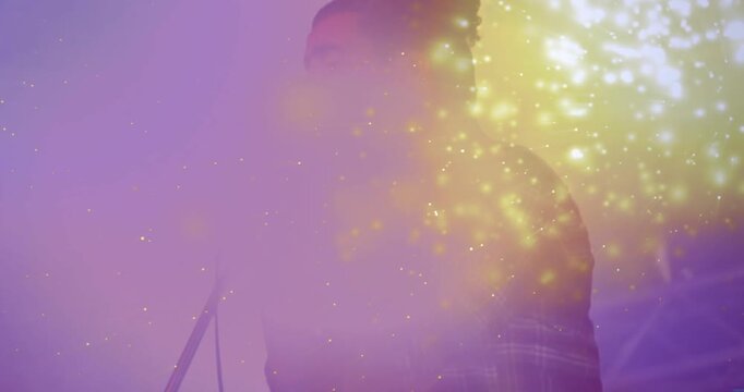 Male singer starting opening line, gripping mic, sparking particle flare and building music climax