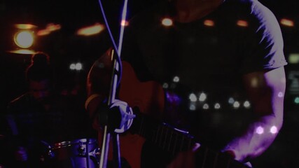 Female photographer raising DSLR capturing music set, framing vocalist singing with bokeh overlays