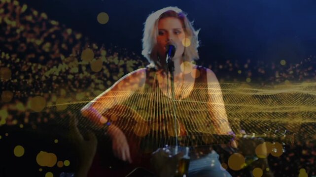 Teen singer strumming and singing on stage starting gold wave over guitar engaging music fans