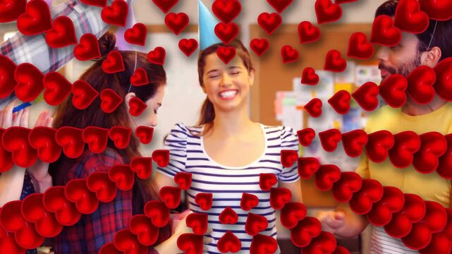 Central woman hugging peer and starting office party, red heart radiating and cone hat being placed
