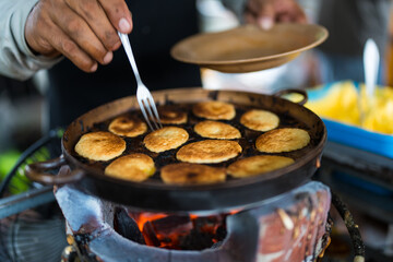 A trader making Khanom Khai. Thai oval sweetmeat made with egg and sugar