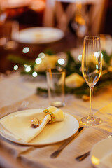 Elegant dining table set for a festive occasion, featuring fine china, sparkling glassware, and decorative elements, creating a warm and inviting atmosphere for celebration