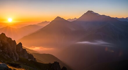 Obraz premium Golden hour bathes the mountain range in a warm, hazy light at sunset