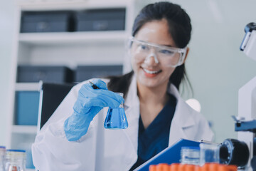 Portrait, science and happy woman on laptop in lab to research chemistry, test or innovation....