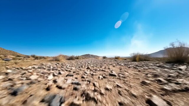 Rocky Desert Landscape with Clear Blue Sky and Distant Mountains