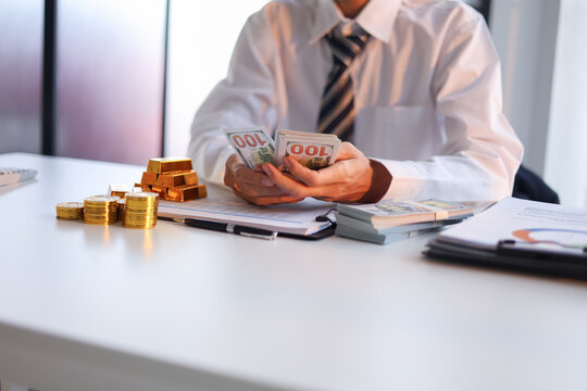 Businessman investing in gold to diversify portfolios hedge against inflation and currency depreciation.