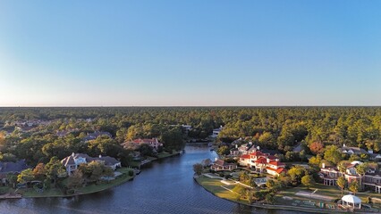 Aerial view of large mansion houses with swimming pool,  in affluent neighborhood  by Woodlands lake, Houston, Texas, expensive suburban homes surrounding by lush green trees, USA