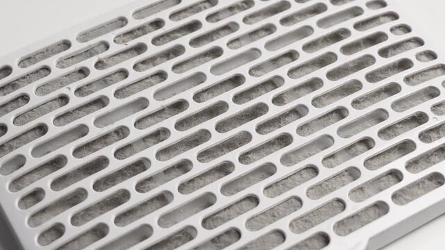 Dust clogged air purifier filter. Dirty used HVAC element. Home appliance component