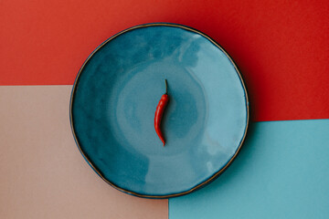 Red pepper on a blue plate.