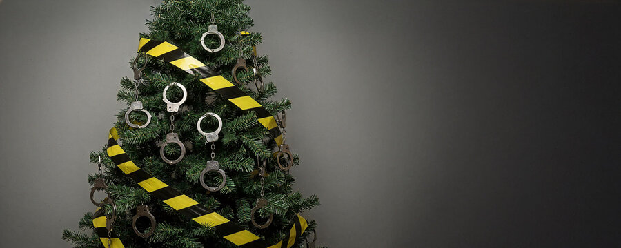 A Christmas tree decorated with handcuffs and barricade tape