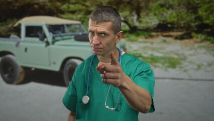 Doctor standing outdoors on street pointing with stethoscope around neck near vintage car in a casual setting, showcasing a thoughtful and analytic expression under natural light.