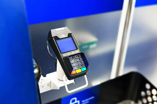 Close-up of a contactless payment terminal (POS machine) for card transactions at a self-checkout counter in a store.