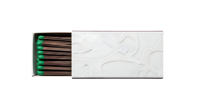 A box of matches with green tips is ready to be used for ignition.