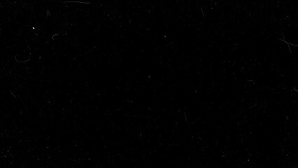 Black background with subtle dust and film imperfections