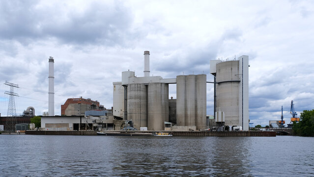 Berlin, Germany, July 6, 2022, view across the river Spree to the Spenner cement plant and the Klingenberg combined heat and power plant operated by vattenfall.
