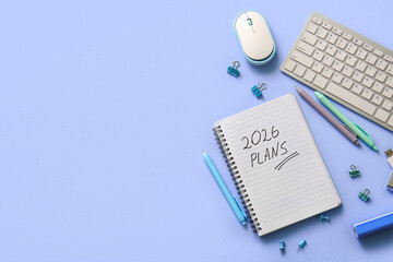 Notebook with Text 2026 PLANS, keyboard and mouse on blue background