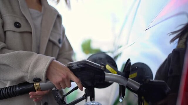 Handyman using an electric drill to install a kitchen cabinet door hinge