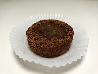 Chocolate cake with pistachio cream on a white background.