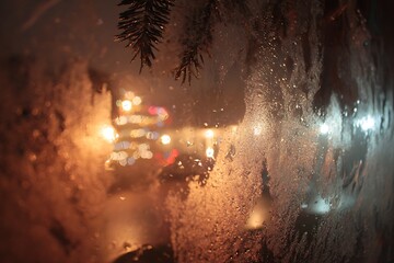 The view from inside looking out a frosty window at night, with Christmas tree lights reflected in the glass 