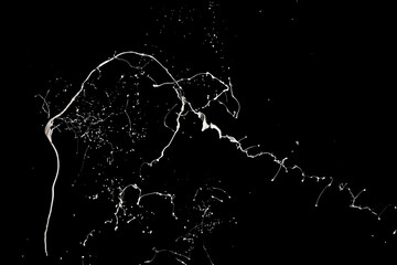 White paint splash isolated on black background.