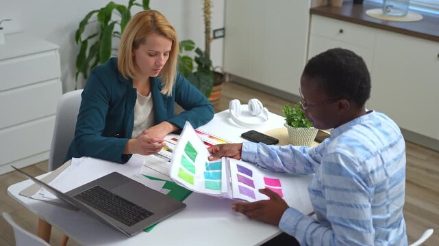 Diverse female designers collaborating on color swatches