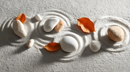Selbstklebende Fototapeten Zen Steine Smooth stones and vibrant autumn foliage rest upon raked white sand creating a scene of tranquility  © irawan