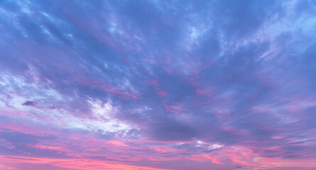 Beautiful bright sunset sky with colorful clouds. Sky background.