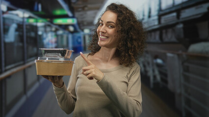 Woman holding takeaway containers and pointing finger to food in ship corridor building; vacation dining joy.