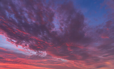 Beautiful bright sunset sky with colorful clouds. Sky background.