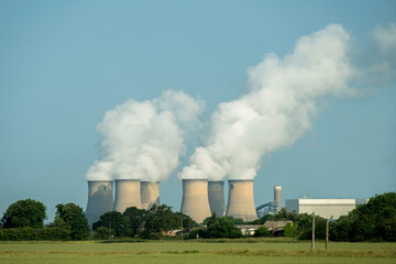 fünf Kühltürme mit dicken weißen Rauchwolken im blauen Himmel, © natros