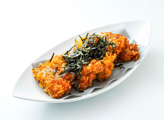 Savor the taste of perfectly fried chicken tenders, artfully topped with seaweed flakes. Enjoy this culinary delight that's ready to elevate your day.