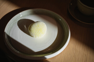 Delicious mango and passion fruit mochi dessert on a plate.