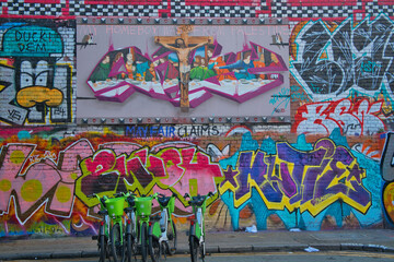 Naklejka premium Murales colorati in strada con biciclette