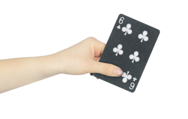 playing card clubs 6 in hand, outstretched hand with black playing card isolated from background