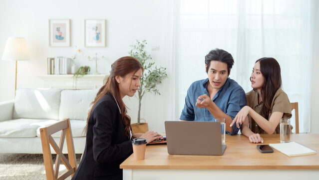 Couple Sharing a Joyful Moment With a Consultant in a Bright Office Space During a Productive Meeting - Powered by Adobe