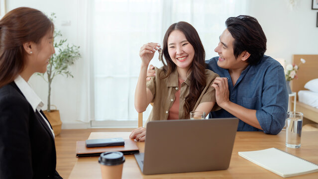 Couple Sharing a Joyful Moment With a Consultant in a Bright Office Space During a Productive Meeting