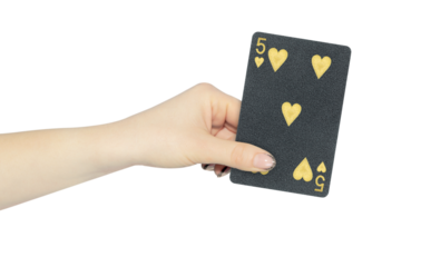 playing card hearts 5 in hand, outstretched hand with black playing card isolated from background