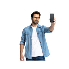 A man taking a selfie with a smartphone isolated on a white background, wearing casual clothing, in a natural pose 