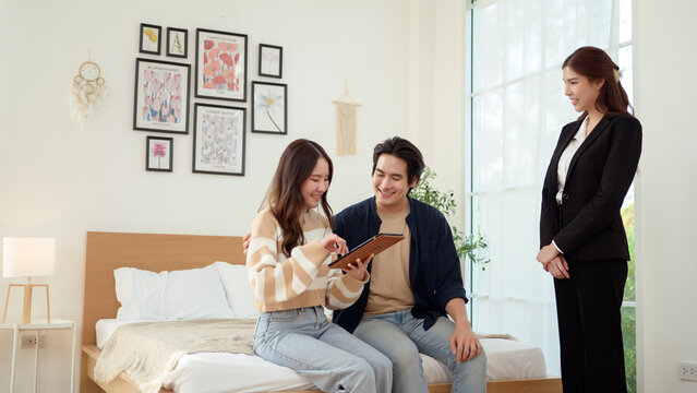 Real Estate Agent Showing a Modern Apartment to Young Couple During Daylight Hours in Bright bedroom - Powered by Adobe
