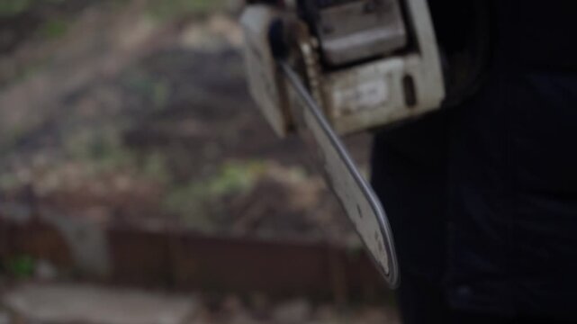 Close-Up Frames of a Chainsaw Ready for Action: Examining the Mechanics and Precision of a Powerful Cutting Tool in a Natural Setting. Video with sound