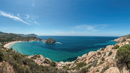 A scenic coastal landscape with a curved beach, rocky formations, and clear blue water under a bright sky.