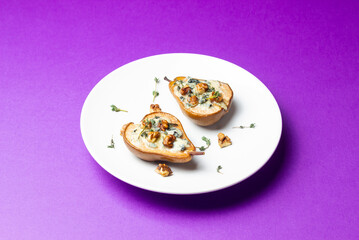 Baked pear with blue cheese, honey, and nuts. Healthy eating. Vegetarian food.