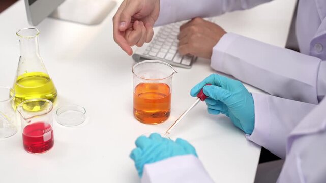 Laboratory healthcare researcher team with scientific expertise, lab equipment, and innovative medical biotechnology software in computer, research new medicines, develop cure. Slow motion. Rigid.