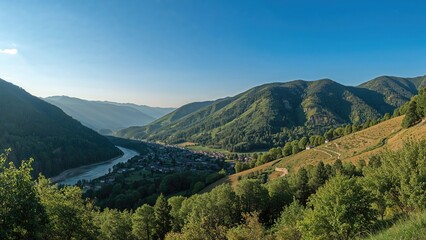 Vast mountain landscape with lush green hills, river valley, and small village, showcasing natural scenery and rural environment.