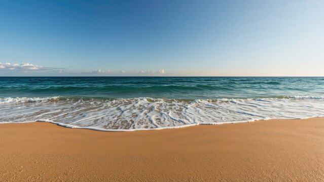 A peaceful sandy beach with gentle waves and a clear blue sky. - Powered by Adobe