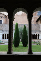 Three cypress treewithin a cloister, between silence and serenity