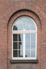 Large mullioned window on a 100-year-old building